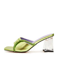 A stylish pair of fashionable women's heel mules in green with a unique star-shaped block heel design.