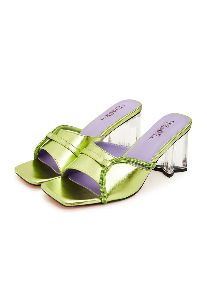 A pair of stylish green block heel mules for women with unique star-shaped heels, perfect for a fashionable look.