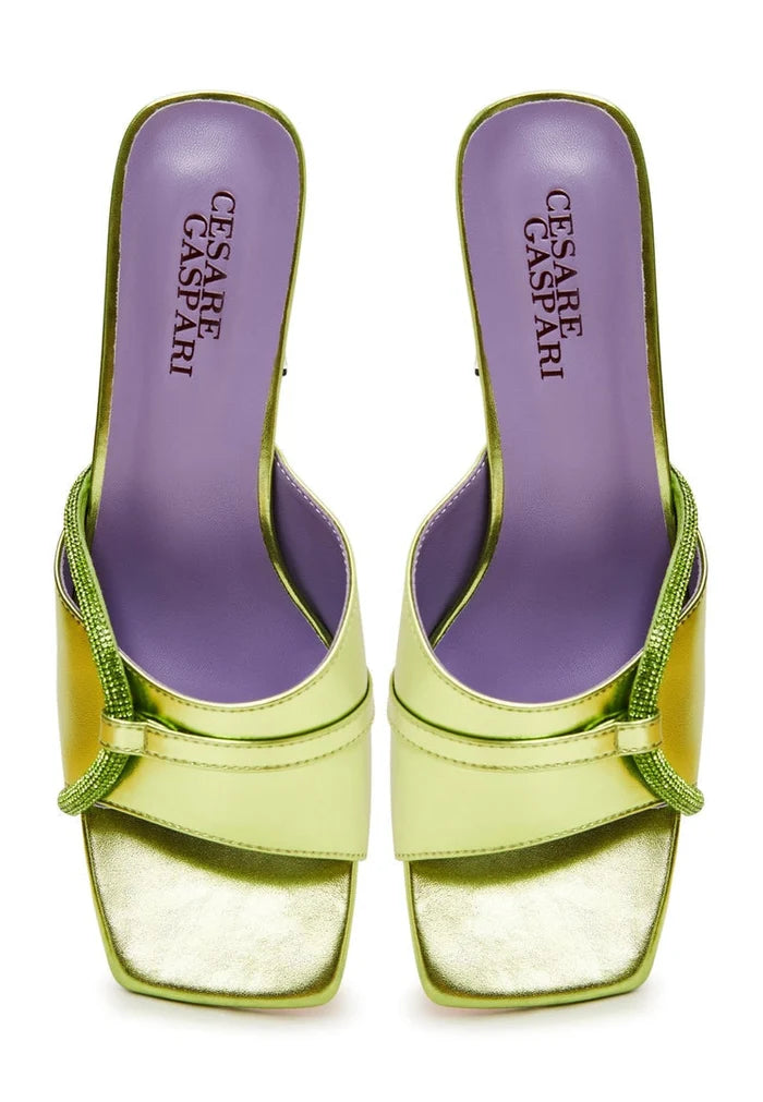 A pair of fashionable women's block heel mules in green, featuring star-shaped heels for a trendy look.