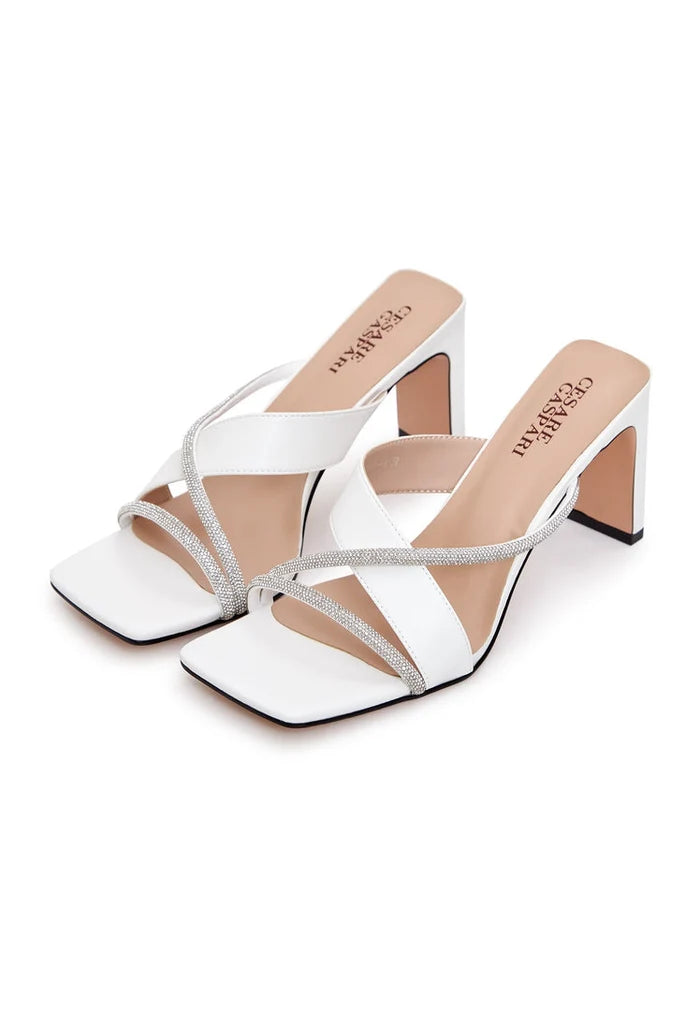 A pair of elegant white high heel sandals with delicate strappy details, perfect for women looking for stylish and sophisticated footwear.