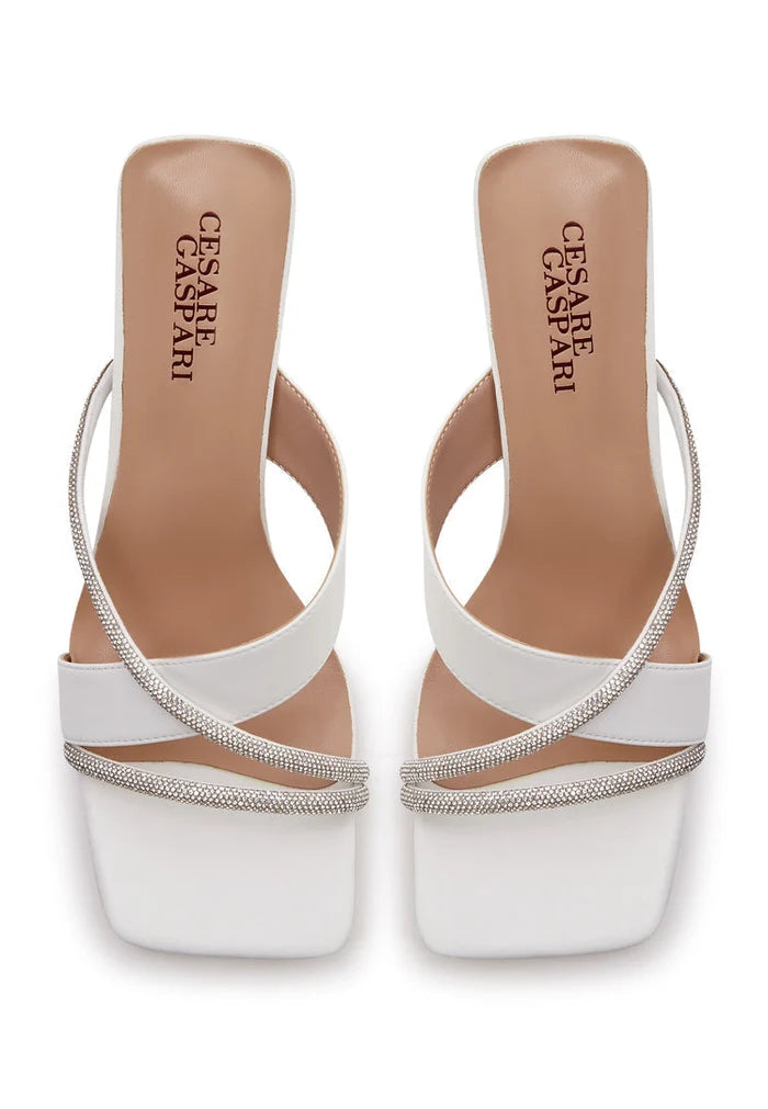 A pair of elegant white high heel sandals for women, featuring a strappy design that exudes sophistication and style.