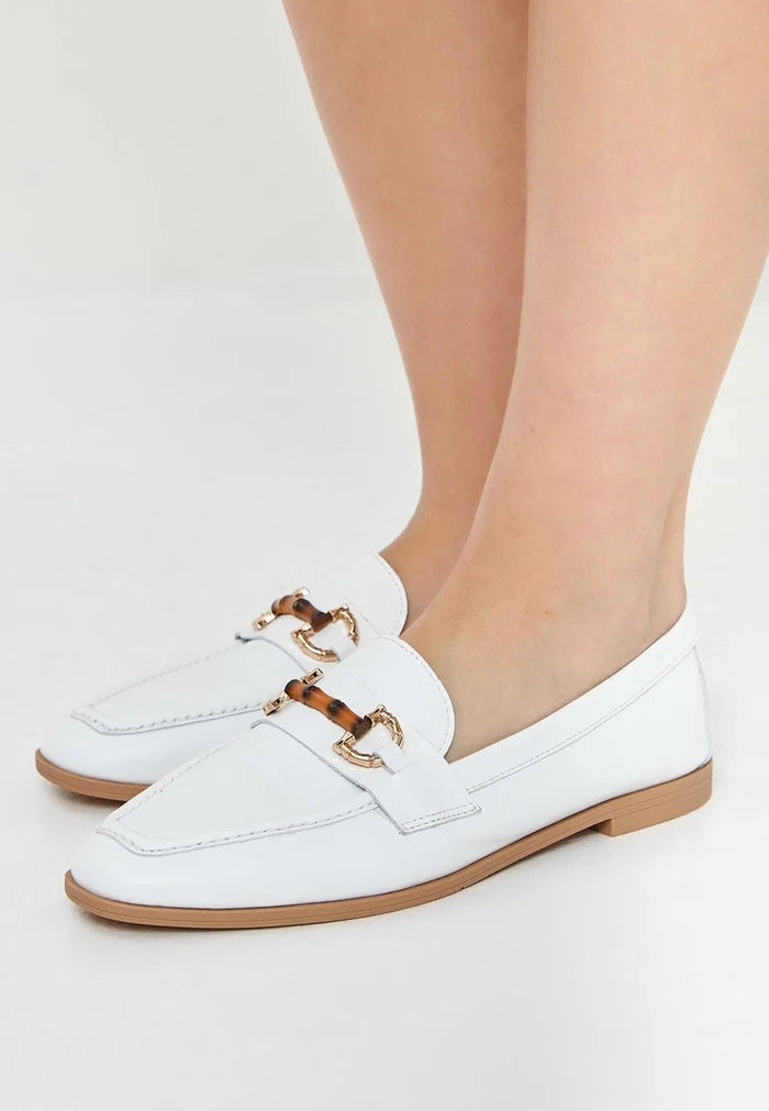 A stylish pair of high-quality leather white loafers, perfect for any occasion, designed by a renowned luxury shoe brand.