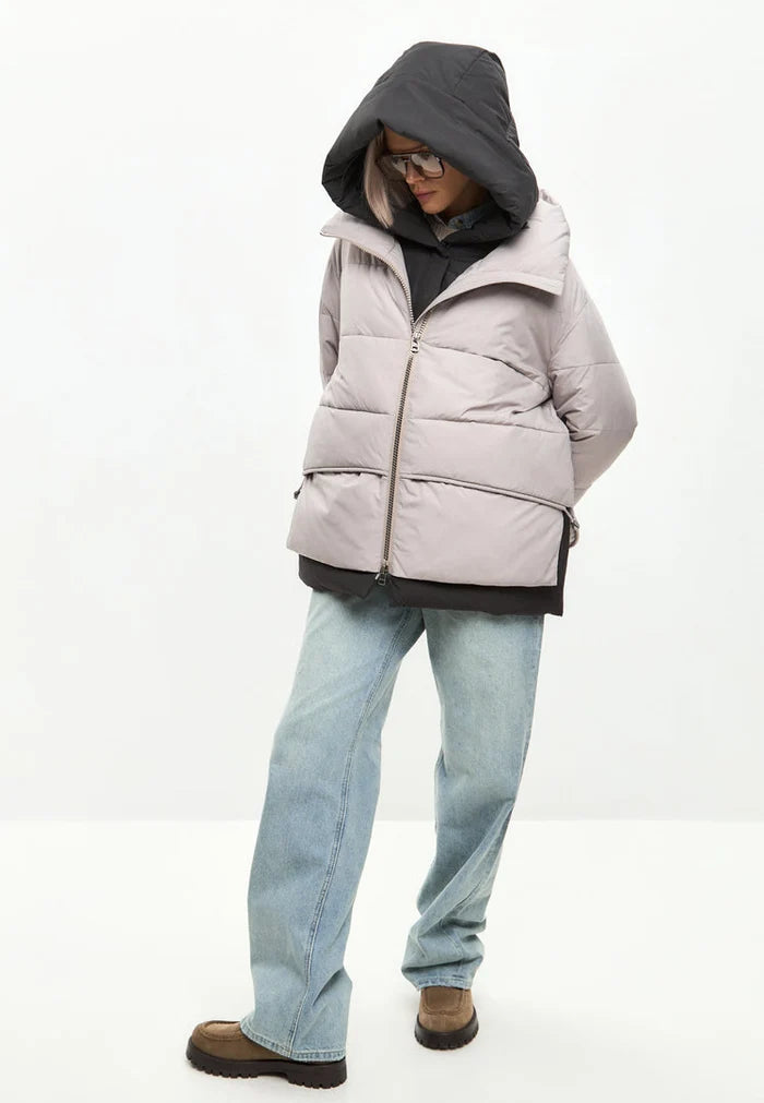 A stylish and fashionable beige hooded puffer jacket, perfect for winter, and a must-have in women's outerwear fashion.