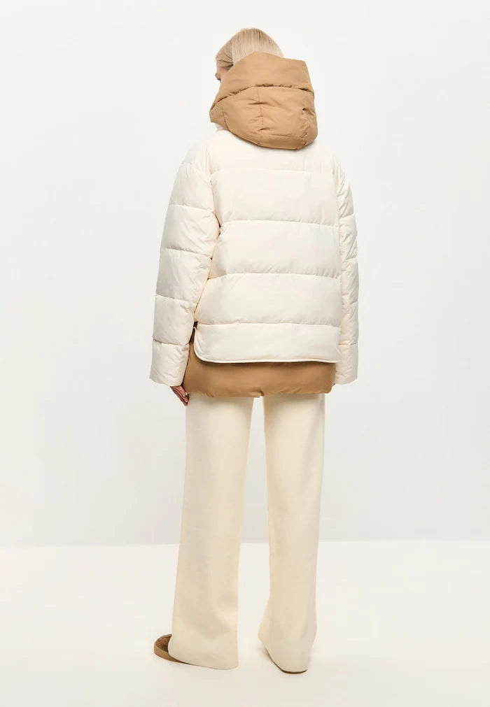 A stylish white hooded puffer jacket, perfect as a winter coat or snow jacket for a trendy outerwear fashion look.