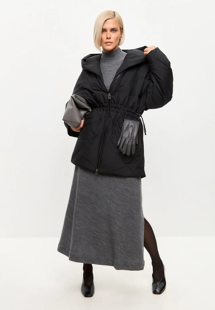 A stylish black hooded quilted jacket for women, perfect for winter and a fashionable outerwear choice.