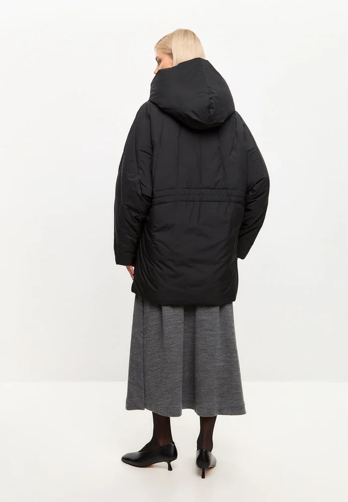 A stylish black hooded quilted jacket for women, perfect for winter.