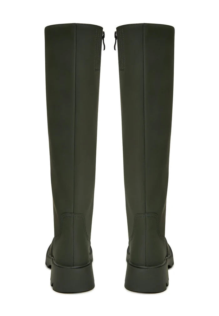 A trendy pair of women's knee-high green boots with chunky soles, ideal for fashionable footwear lovers.