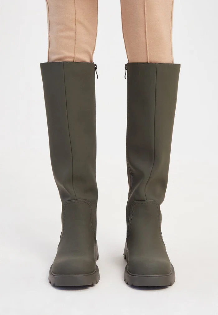 A stylish pair of knee-high chunky sole green boots for women's fashion footwear, perfect for anyone looking for trendy boots.
