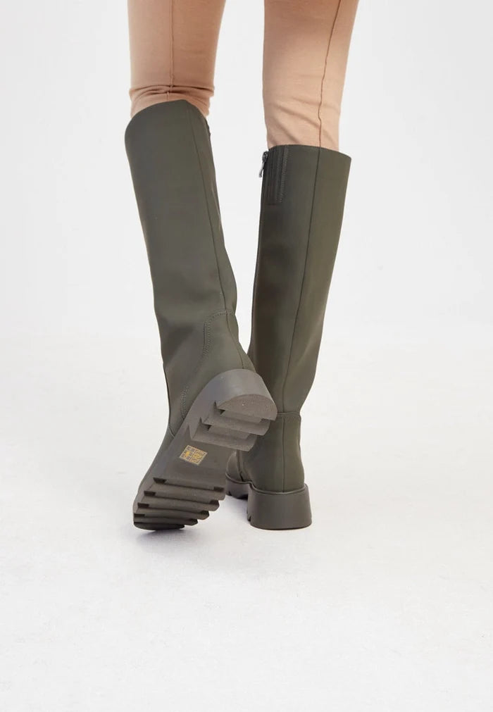 A stylish pair of knee-high, chunky sole green boots for women's fashion footwear, perfect for those looking for trendy boots.