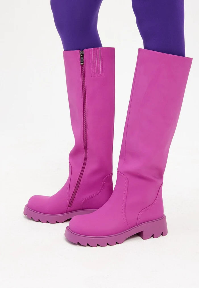A chic pair of pink knee-high chunky sole boots, perfect for the trendy woman's fashion footwear collection.