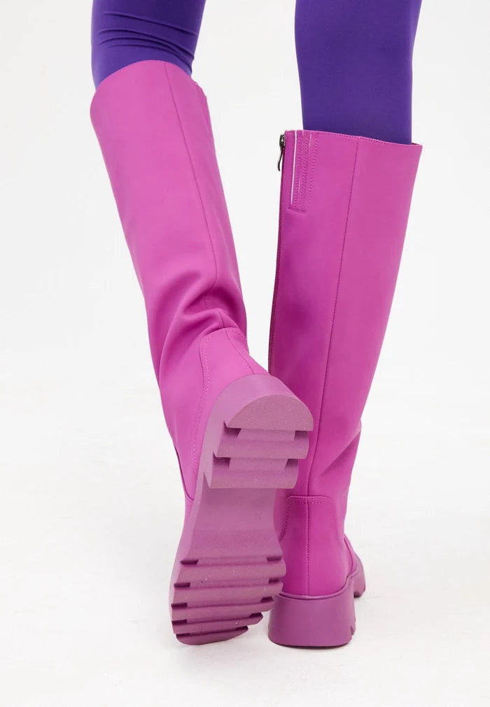 A trendy pair of pink knee-high boots with chunky soles, the perfect addition to any women's fashion footwear collection.