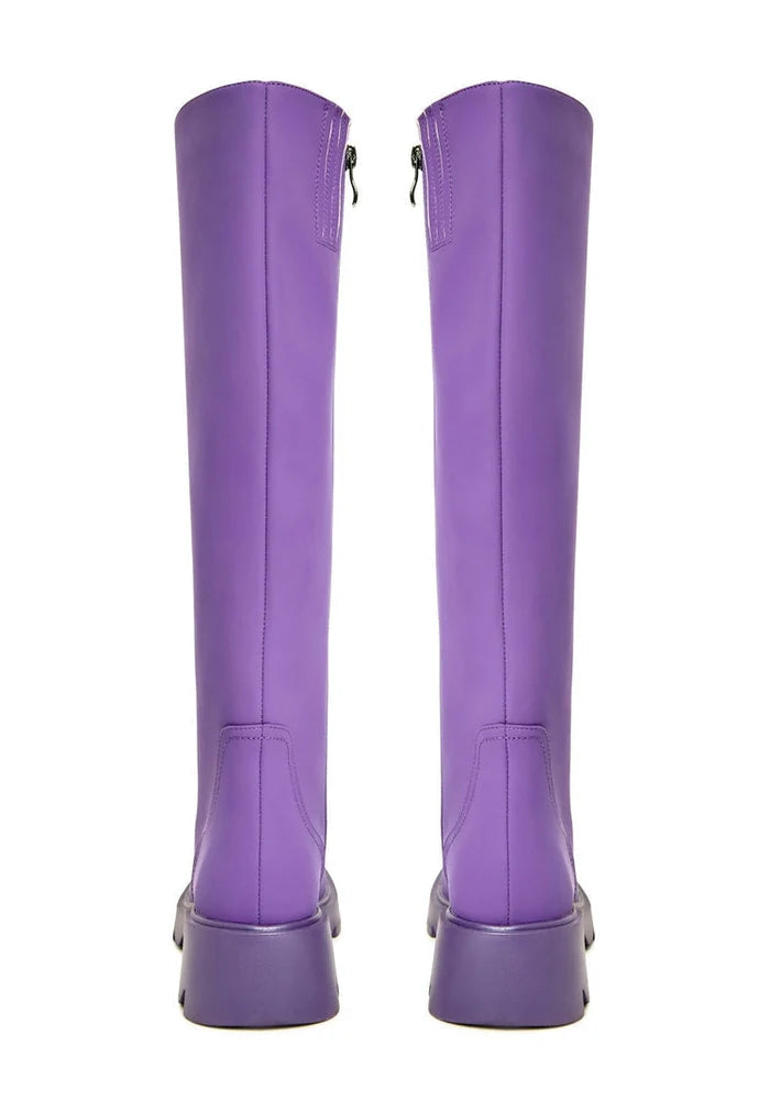 A pair of trendy knee-high chunky sole purple women's fashion boots.