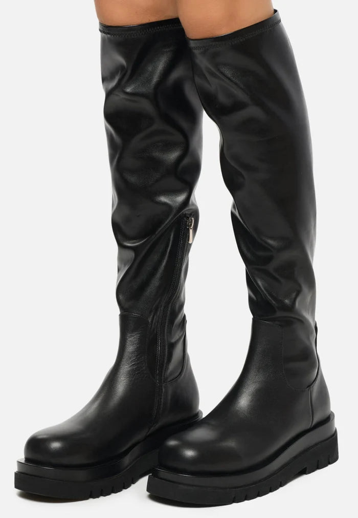 A stylish pair of women's knee-high leather lug boots, the perfect combination of fashion and function.