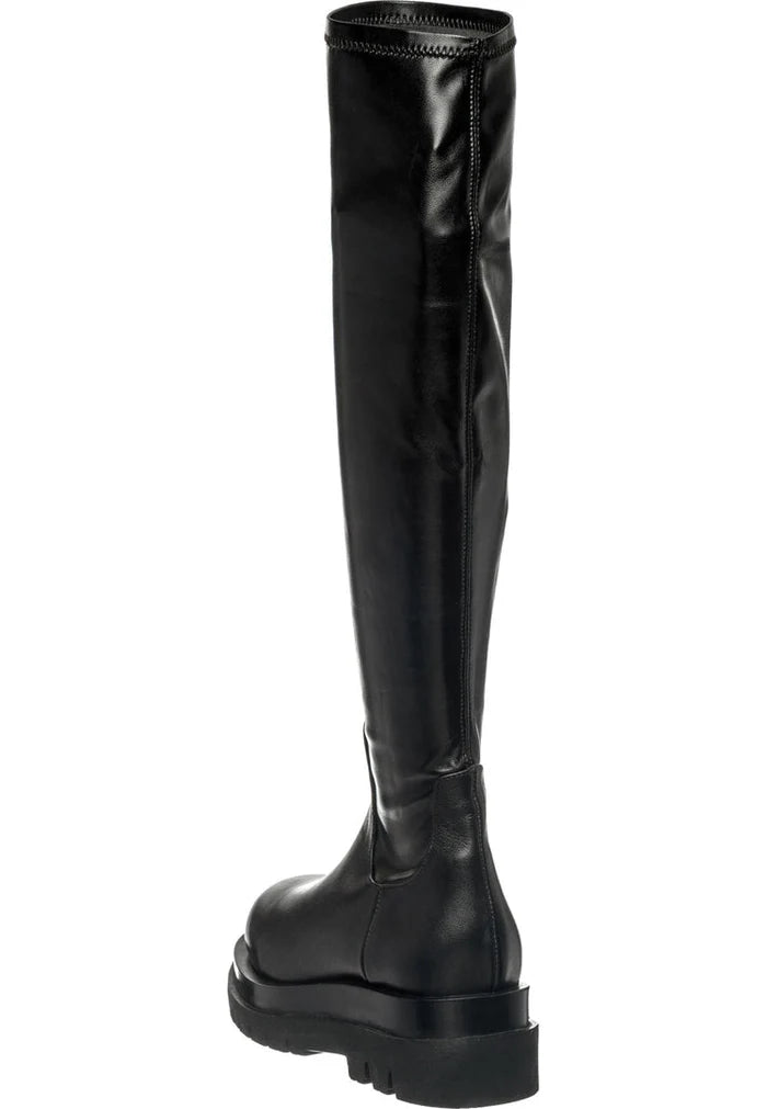 A stylish pair of women's knee-high leather lug boots, perfect for any fashionable outfit.