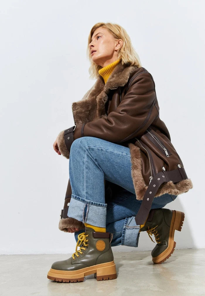 A trendy pair of fashionable green lace-up ankle boots for women, perfect for adding a stylish touch to any outfit.