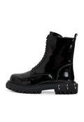 A close-up view of black lace-up combat boots with chunky soles, perfect for a stylish and edgy look.