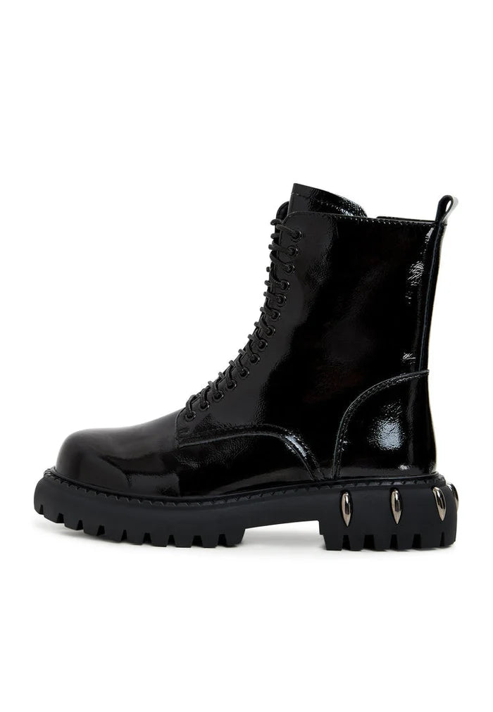 A close-up view of black lace-up combat boots with chunky soles, perfect for a stylish and edgy look.