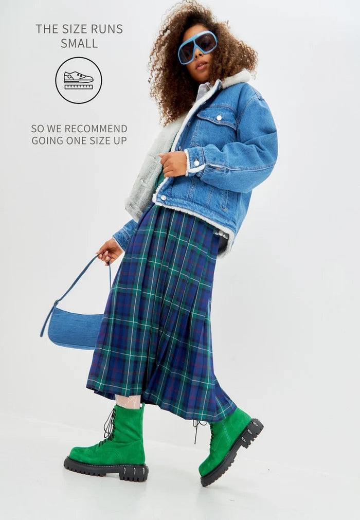 A pair of stylish green lace-up combat boots with a chunky sole, perfect for adding a military-inspired flair to women's fashion footwear.