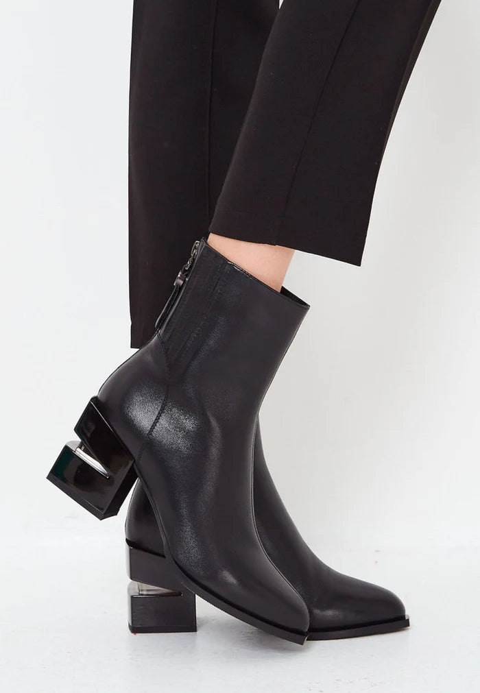 A stylish pair of black leather ankle boots with a block heel, perfect for women looking for heeled ankle boots.