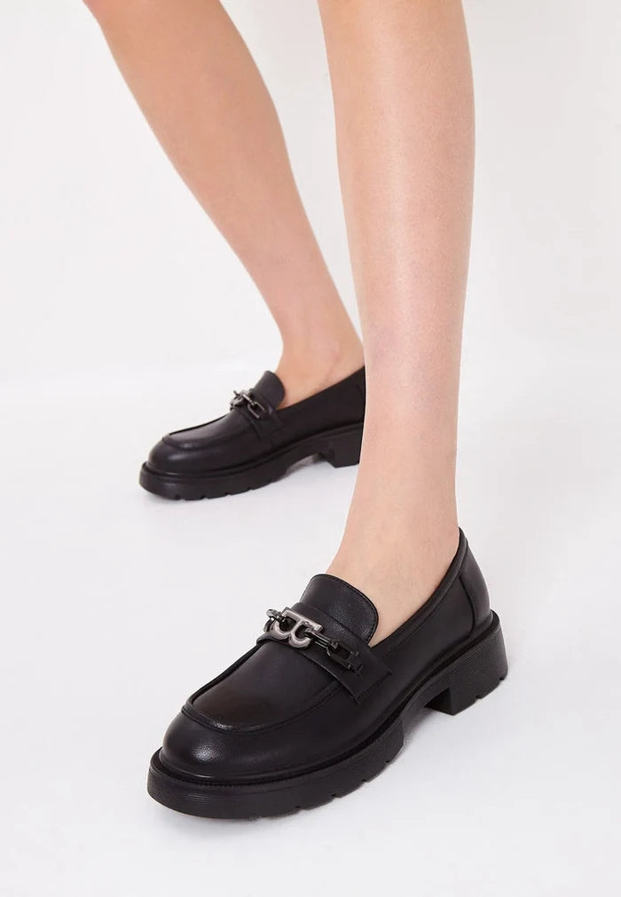 A stylish pair of black leather loafers with block heels, perfect women's footwear for a fashionable look.