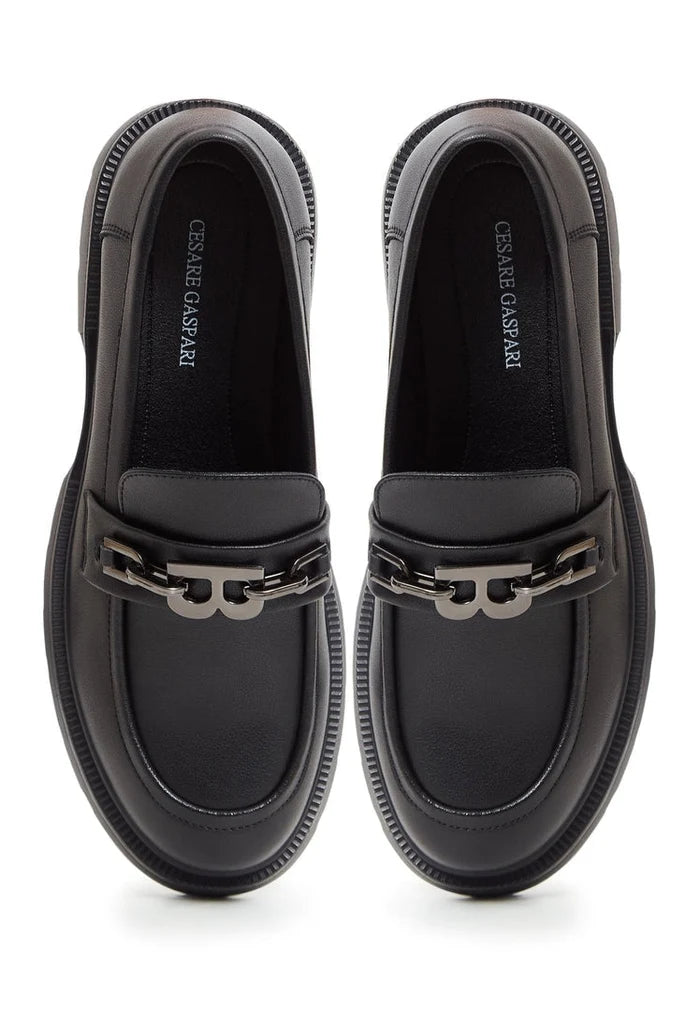 A pair of black leather loafers with block heel design, stylish women's footwear perfect for a fashionable look.