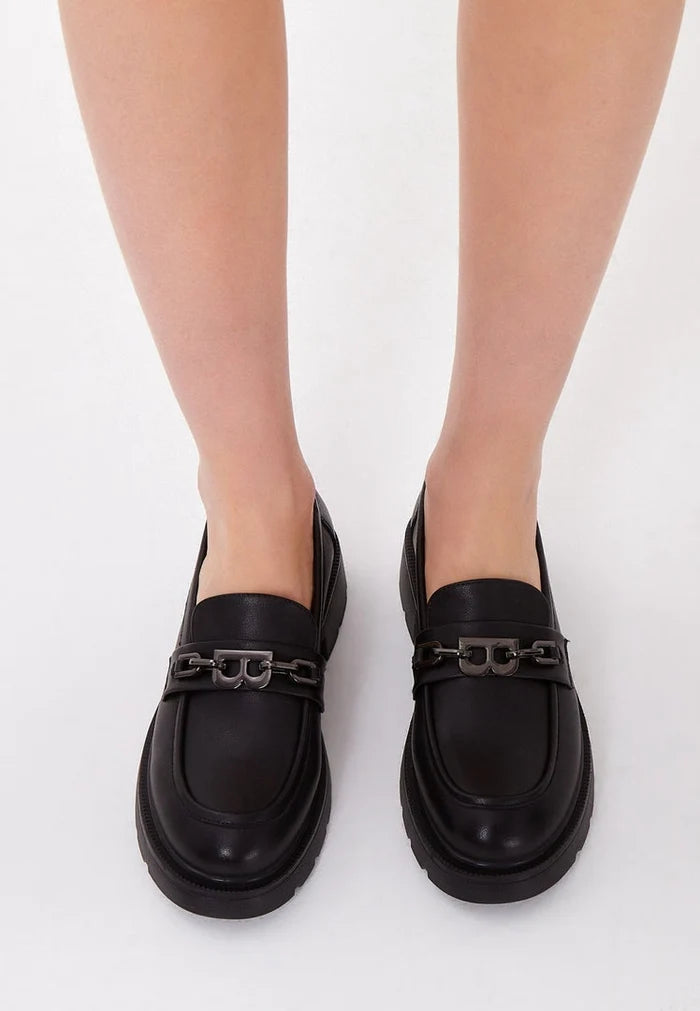 A stylish pair of women's black leather loafers with block heels, perfect for fashionable footwear enthusiasts.