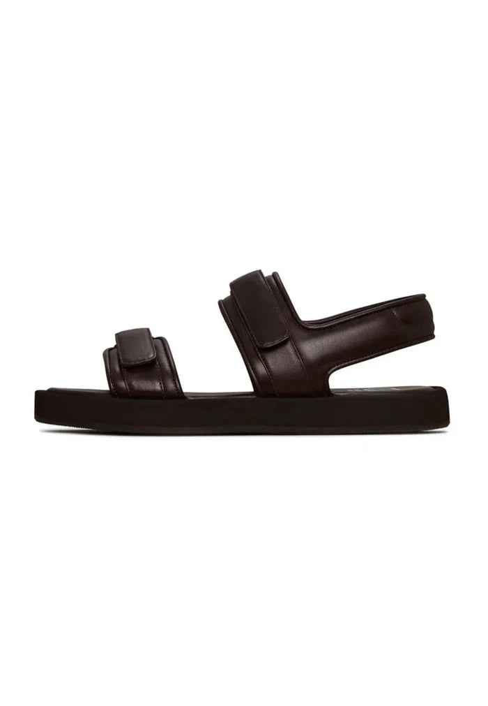 A pair of dark brown leather women's sandals with velcro closure for comfort.