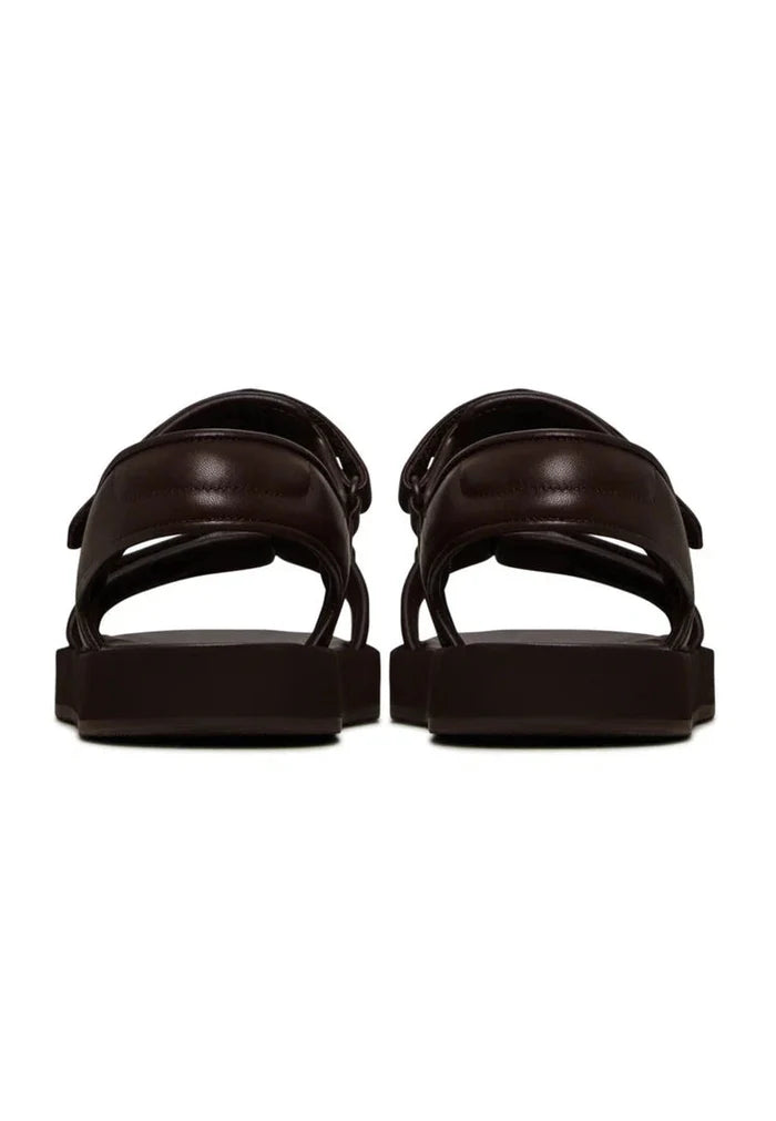 A pair of stylish women's dark brown leather sandals with velcro closure for ultimate comfort.