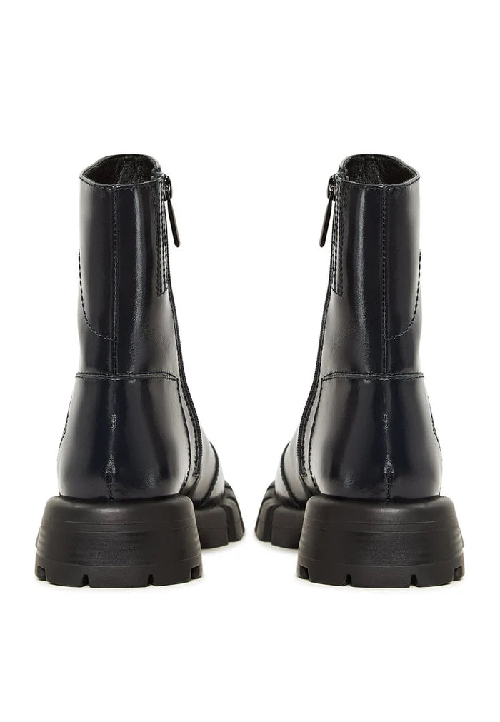 A trendy pair of women's leather ankle boots in a stylish blue color with a flat sole design.