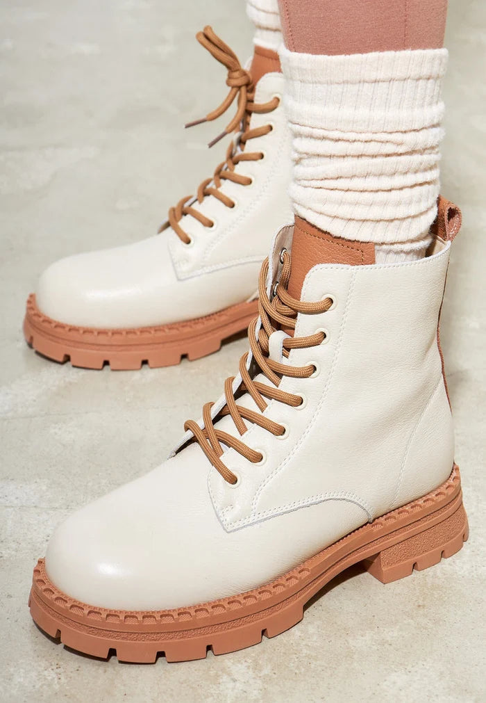 A stylish pair of off-white lace-up leather ankle boots for women's footwear fashion.