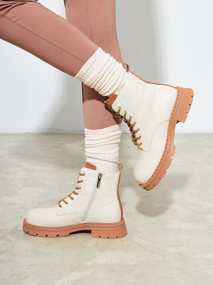A pair of stylish off-white leather lace-up ankle boots for women - perfect fashion footwear.