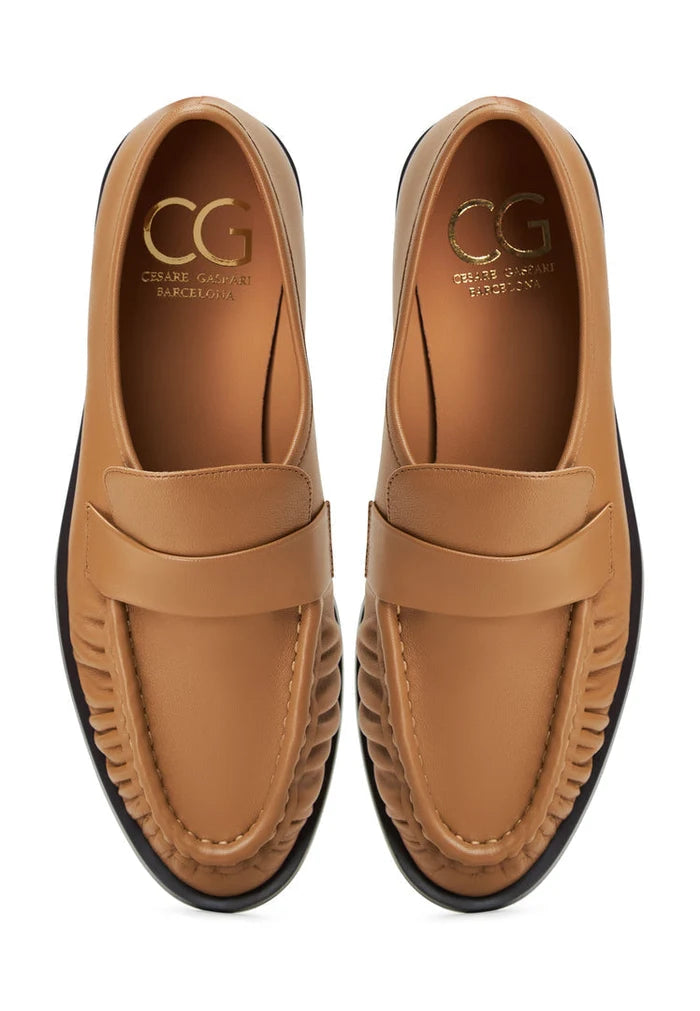 A classic pair of beige leather loafers named Isabel, perfect for women's style with timeless elegance.