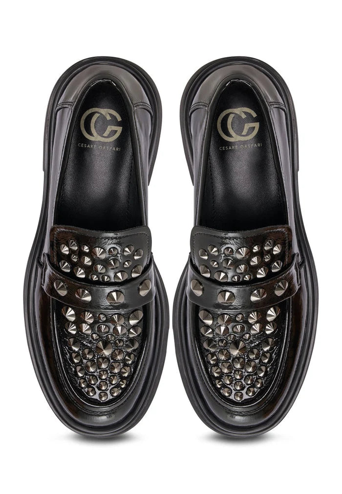 A pair of black leather loafers inspired by rockstar fashion, the perfect addition to men's stylish footwear.