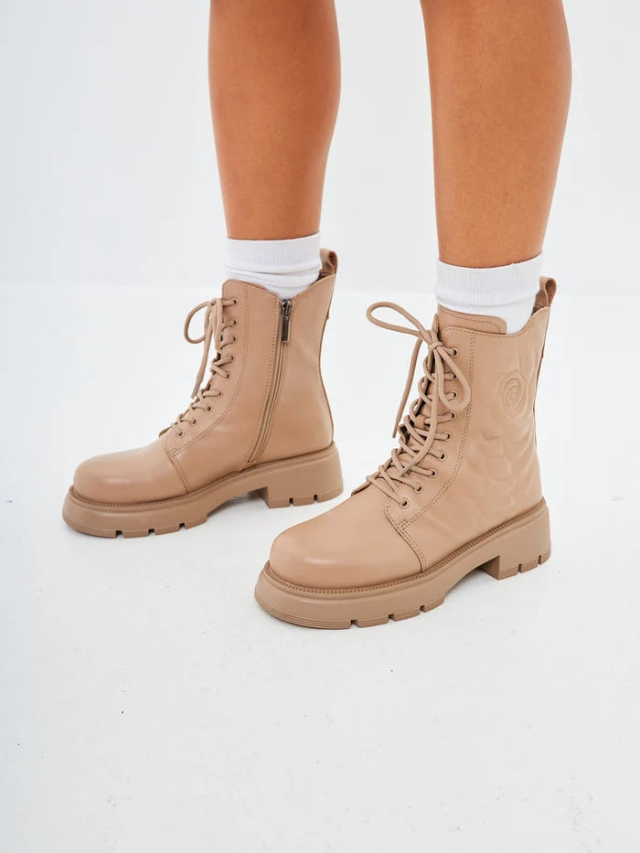 A stylish pair of beige leather platform ankle boots for women, perfect for adding a fashionable flair to your outfit.