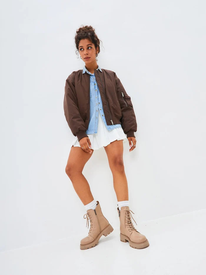 A stylish pair of beige leather ankle boots with a platform design, perfect for women's fashion footwear.