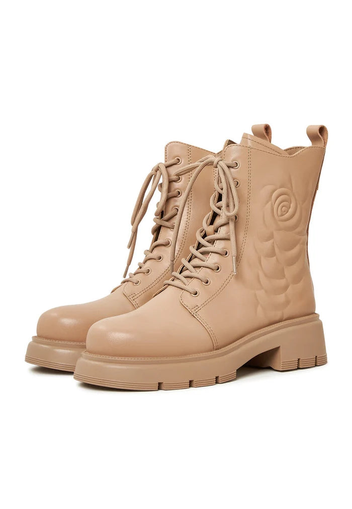 A stylish pair of women's leather ankle platform boots in beige, the perfect fashion footwear for any outfit.
