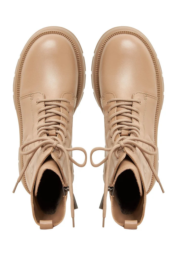 A trendy pair of beige leather ankle platform boots for women, ideal for fashion footwear enthusiasts.