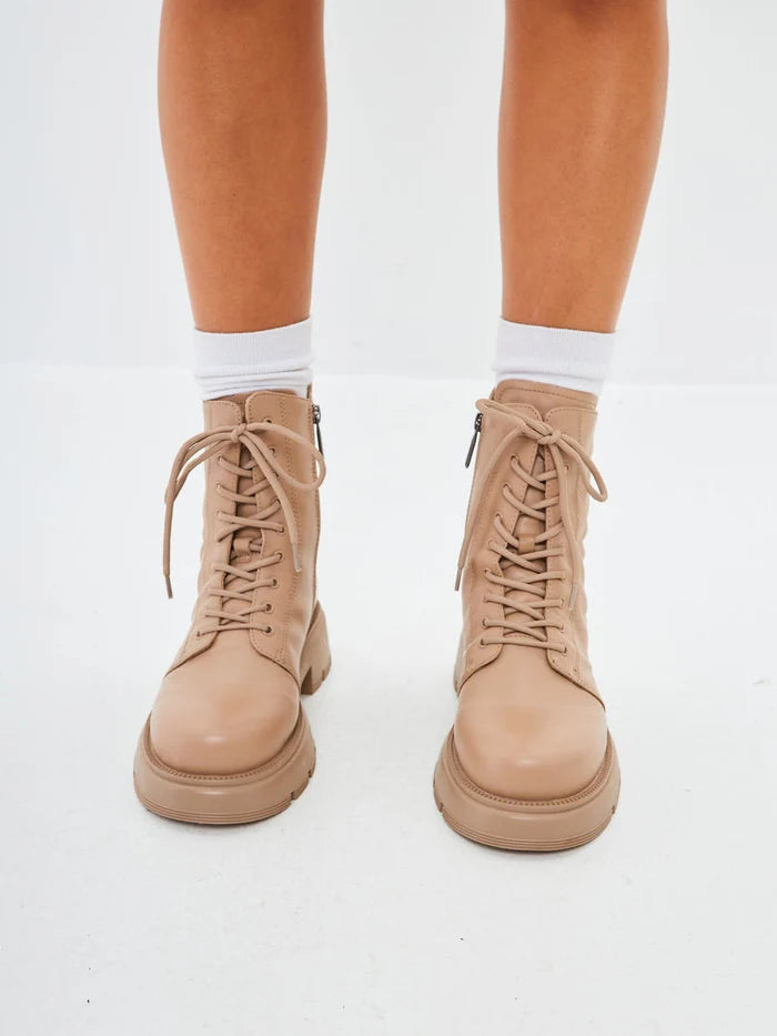 A stylish pair of beige leather ankle platform boots, perfect for fashionable women's footwear.