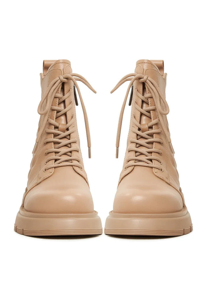 A pair of stylish beige leather platform ankle boots for women - a must-have fashion footwear item.