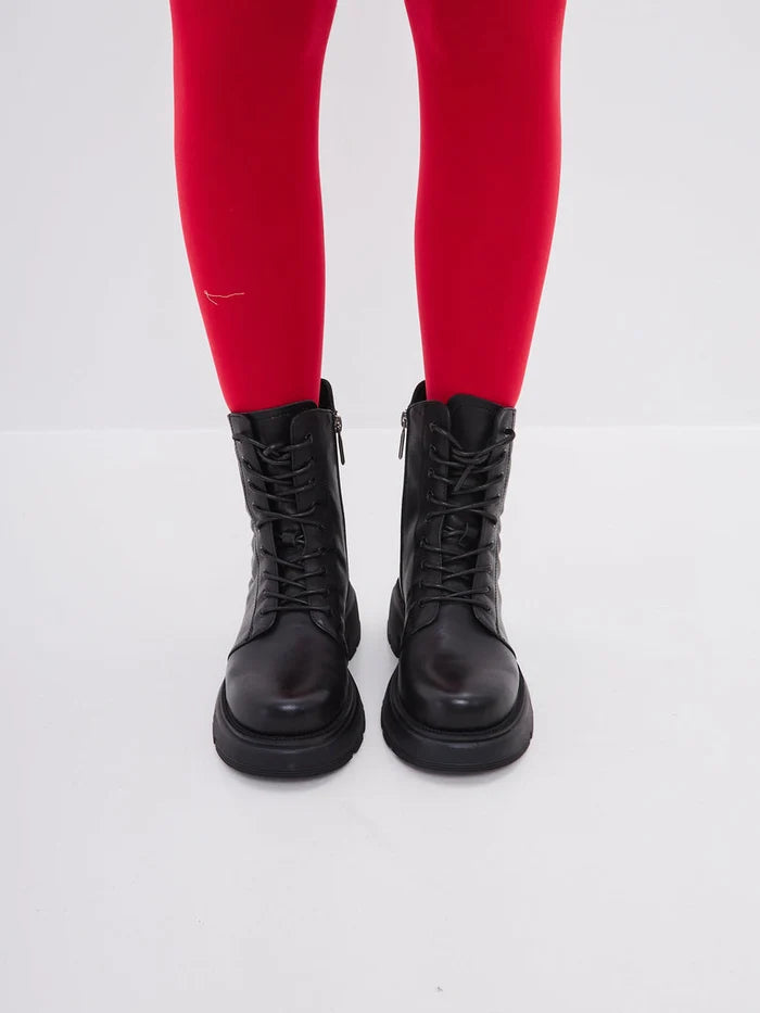 A fashionable pair of women's high heel black leather platform ankle boots.