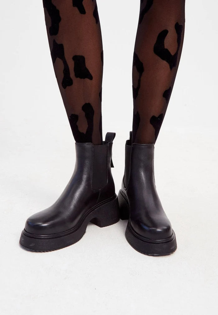 A stylish pair of high heel, black leather platform ankle boots for women, a fashionable choice for any outfit.
