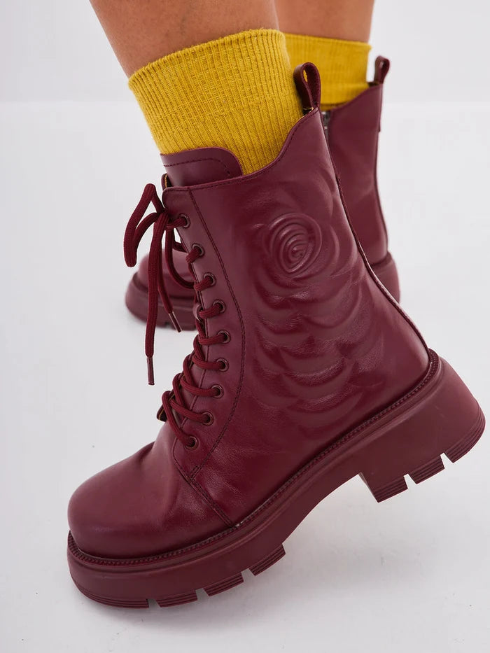 A stylish pair of women's leather platform ankle boots in a trendy bordeaux color, featuring high heels - perfect for fashion-forward individuals looking for fashionable ankle footwear.