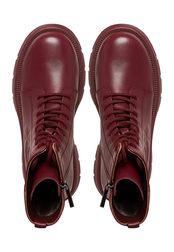 A stylish pair of bordeaux leather platform ankle boots for women, featuring high heels and are a fashionable choice for any outfit.