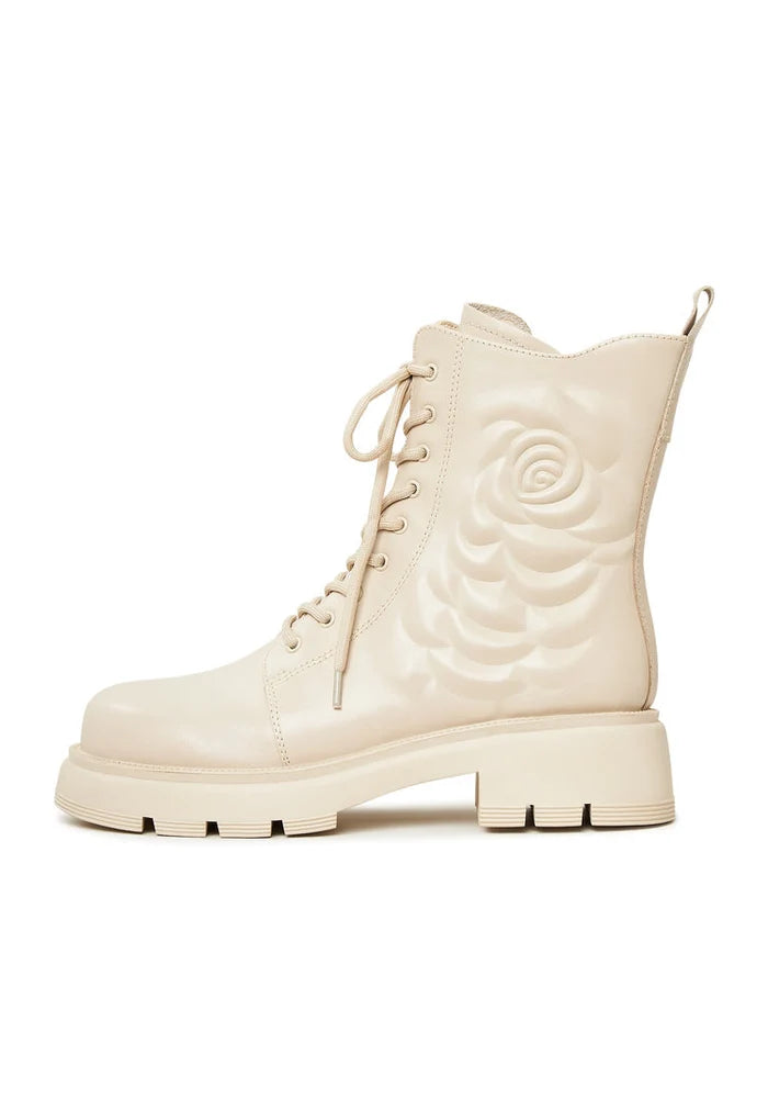 A stylish pair of leather platform ankle boots in ivory, perfect for a chic and fashionable look.