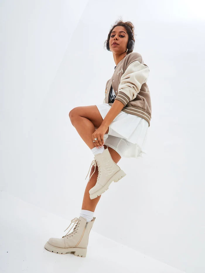 A pair of stylish leather platform ankle boots in ivory, perfect for adding a touch of sophistication to any outfit.