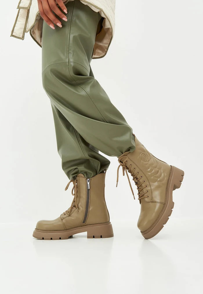 A stylish pair of green leather platform ankle boots, perfect for making a fashion statement.