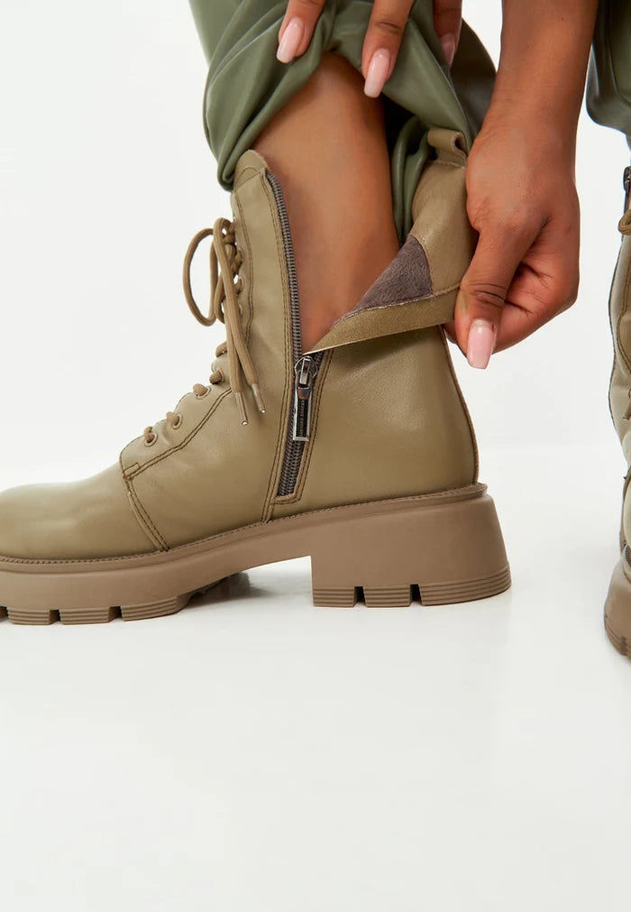 A stylish pair of green leather platform ankle boots, perfect for making a statement.