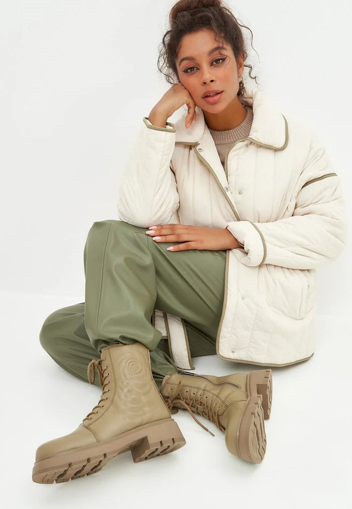 A stylish pair of green leather platform ankle boots, perfect for making a statement with any outfit.