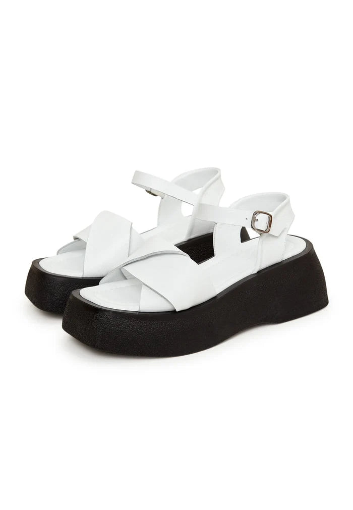 A trendy pair of white leather platform sandals, perfect for stepping into summer in style.