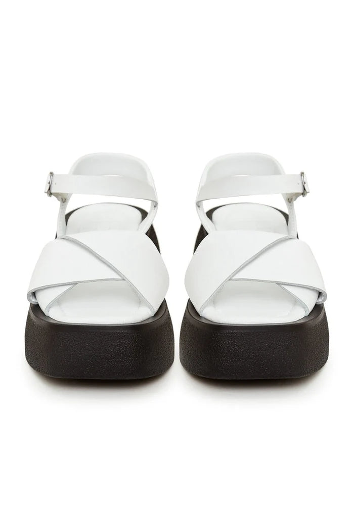A pair of stylish white leather platform sandals with a chunky sole, perfect for summer outings and adding extra height.